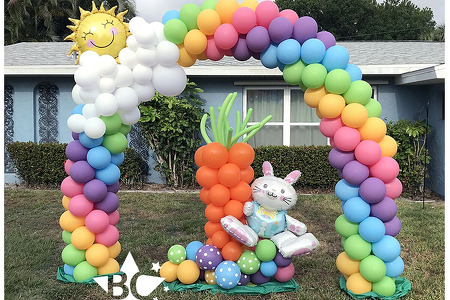 Easter Balloons- Rainbow Arch with clouds and sun. Easter Bunny with carrot and eggs balloon sculpture in Melbourne FL by Blank Canvas Event Decor