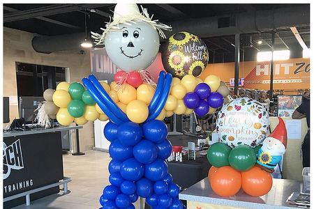 Fall Balloon Decor- 7' balloon scarecrow sculpture and our pumpkin shaped balloon mini photo frame. Balloons Melbourne FL