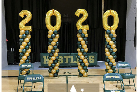 Graduation Balloon Columns in Green and Gold with large gold 2020 numbers on top.