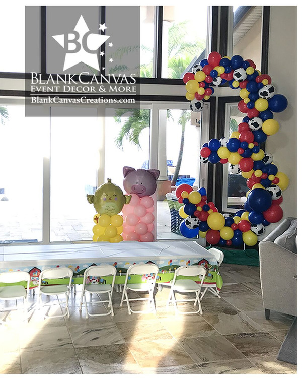 Farm Animal Theme Balloon Décor with cow, chick, pig and horse balloon columns. Then there is a 9' tall organic balloon sculpture of a number 3 in red, yellow, and blue with accents of cow prints.