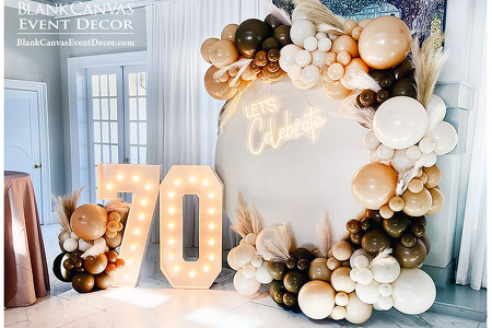 Lighted Marquee Number 70, Round Backdrop and Deluxe Organic Balloon Garland in browns and neutrals for a 70th BD In Melbourne FL