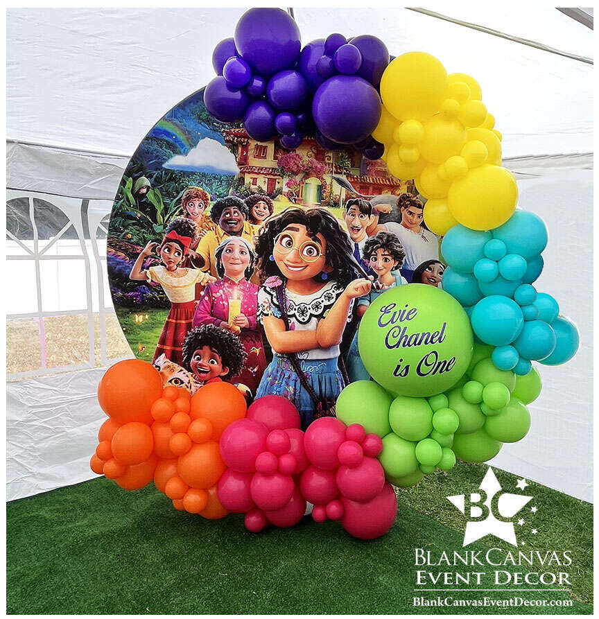 Encanto First Birthday Organic Balloon Garland around a Backdrop in Palm Bay FL