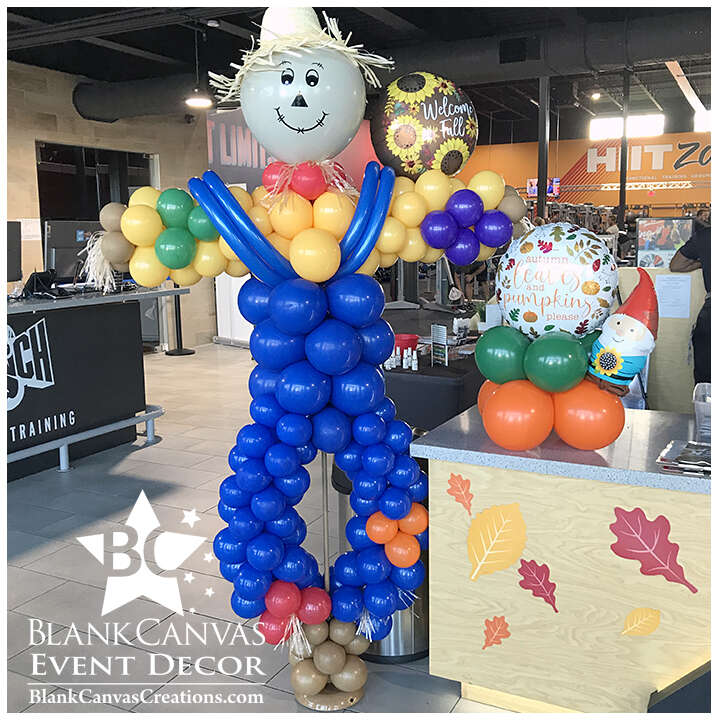 7' Scarecrow Balloon Sculpture for Fall Harvest Event. He has a straw hat, yellow shirt and blue overall with patches. Balloons, Melbourne Florida