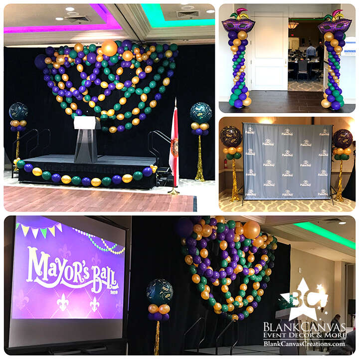 Mardi Gras Balloon Decor with Organic Balloon Garland with swags of beads behind the stage, Mardi Gras balloon Columns at Hilton Rialto Melbourne FL