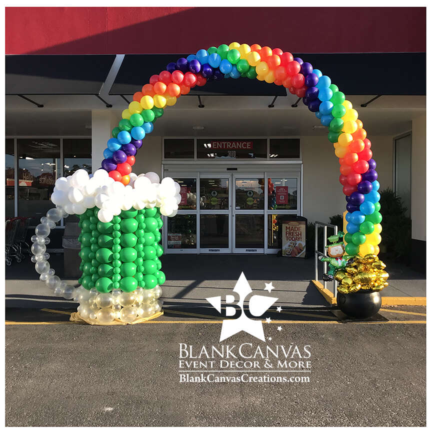 St Patrick's Day Rainbow Balloon Arch with giant green beer mug balloon sculpture on one end and a pot of gold with leprechaun on the other end. at Winn Dixie in West Melbourne FL